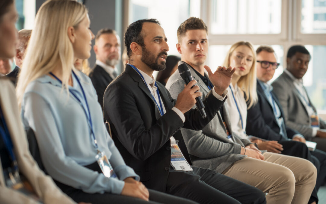 A man speaks with a microphone at a solar energy convention