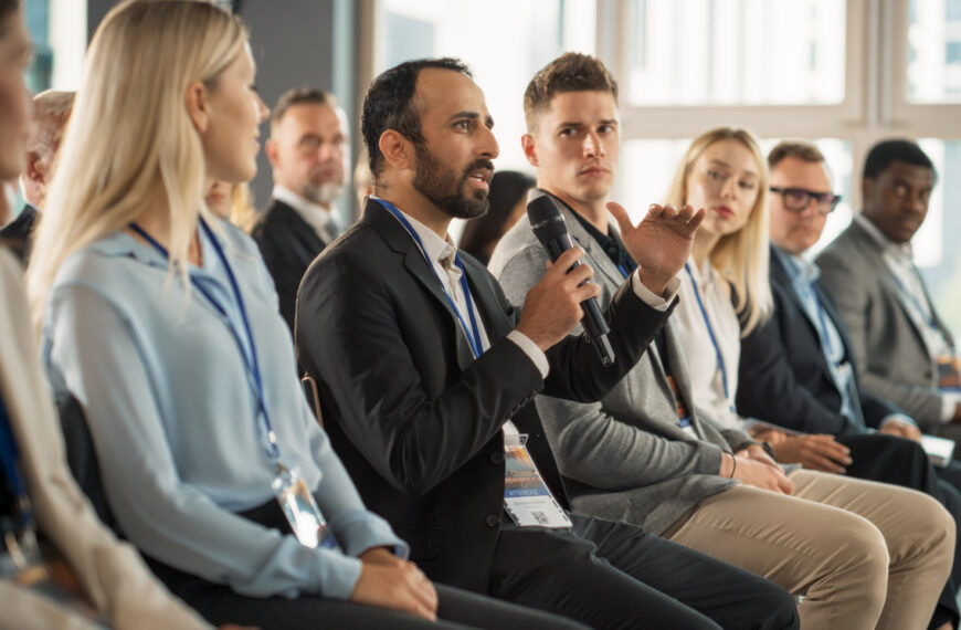 A man speaks with a microphone at a solar energy convention